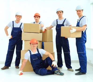Movers loading boxes and furniture into a van for a local move